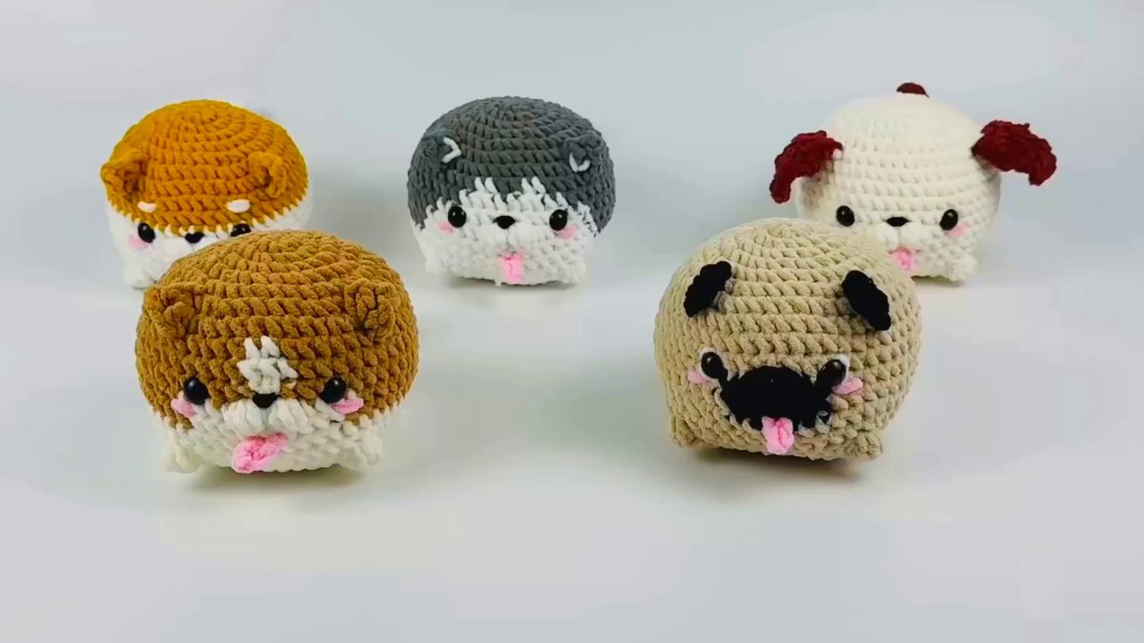 Craft Your Own Adorable Crochet Dog Bun: A Beginner's Step-by-Step Guide 2 A close-up shot of a hand holding a completed red crochet ear piece, showcasing the intricate stitches against a light wooden background.