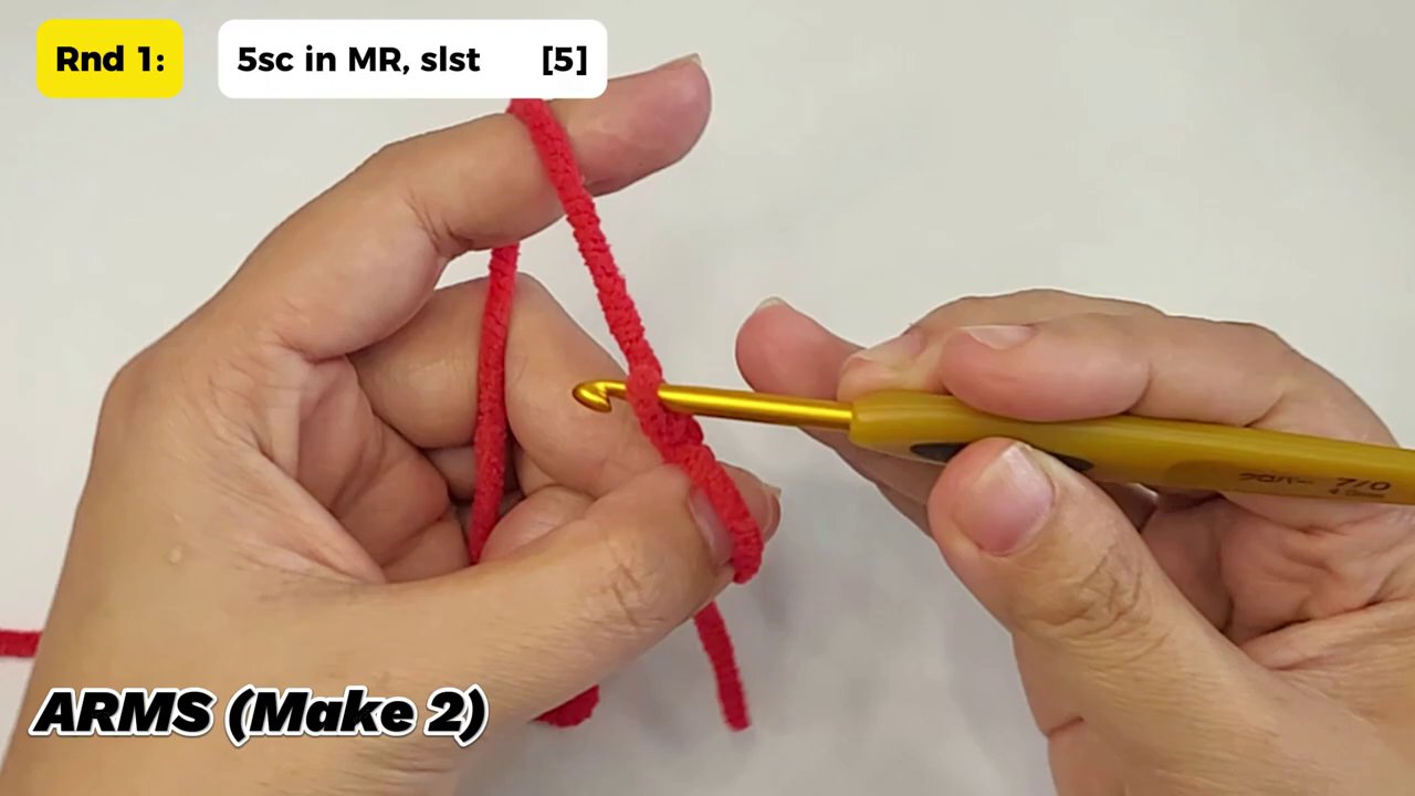 Craft a Festive Snowman Couple: A Cozy Crochet Tutorial for the Holidays 3 Hands working with black yarn and a red hook, meticulously crafting one of the snowman's small, round buttons.