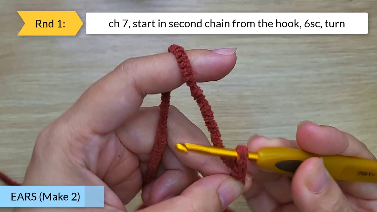 Craft Your Own Adorable Crochet Dog Bun: A Beginner's Step-by-Step Guide 4 The hands continue crocheting the white piece, now more developed, with detailed stitch instructions for a later round visible in a text box overlay.