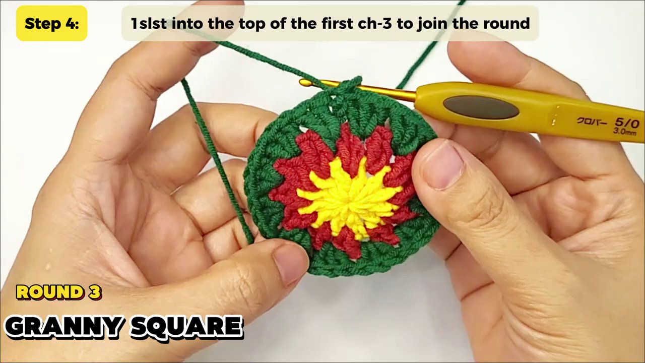 Craft a Festive Granny Square Christmas Tree: A Step-by-Step Crochet Tutorial 5 The granny square has grown significantly, showing a clear, defined square shape with a bright pattern of green, red, and yellow clusters.