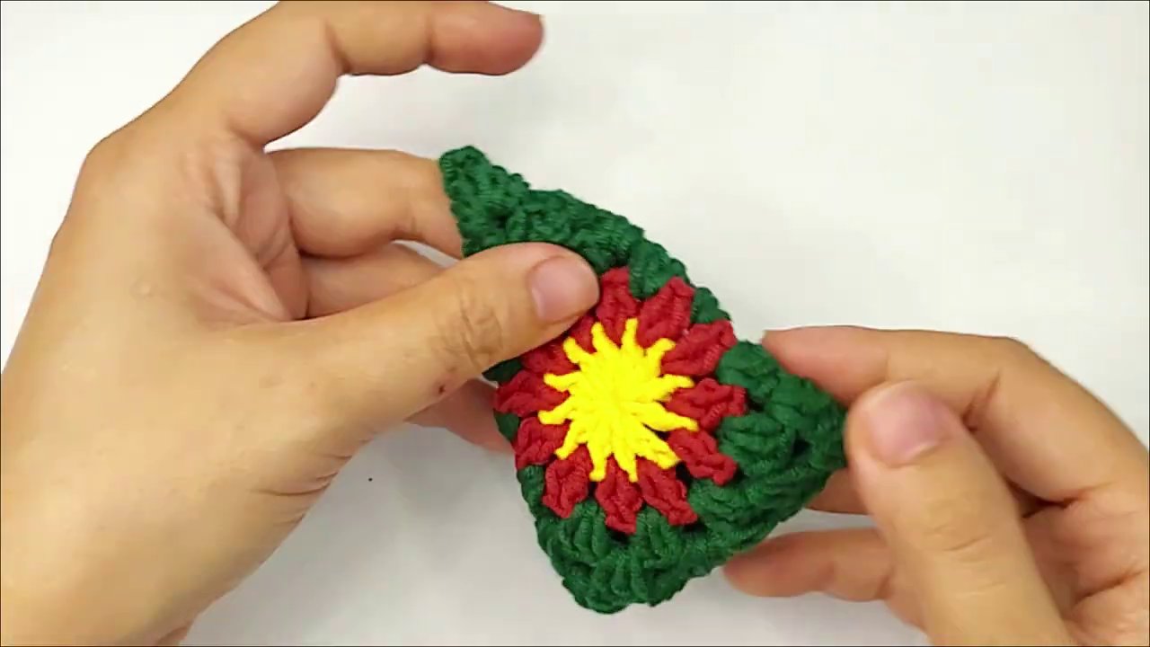 Craft a Festive Granny Square Christmas Tree: A Step-by-Step Crochet Tutorial 7 The brown trunk piece is more developed, showing several rows of tight single crochet stitches, forming a solid rectangular shape.