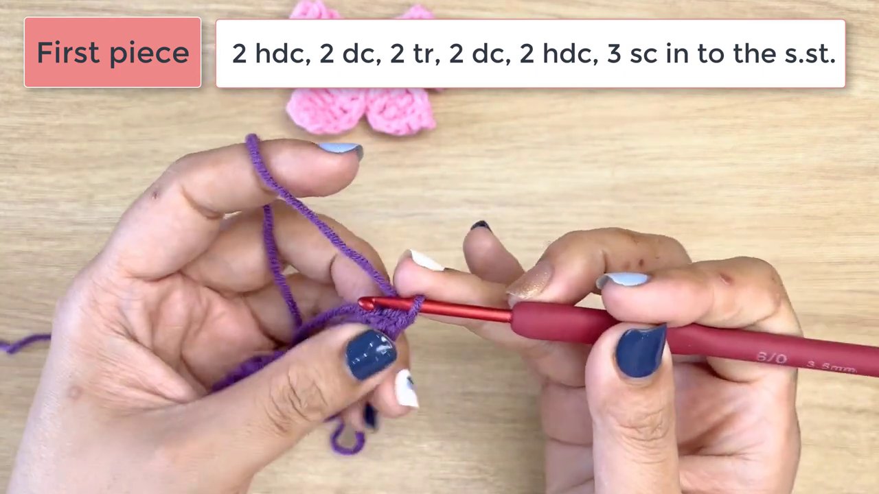 Master the Art of Crochet: A Step-by-Step Guide to Crafting a Beautiful Bow 8 A final shot shows both the completed purple bow and a pink bow, with hands poised to adjust or join them, demonstrating the finished project.