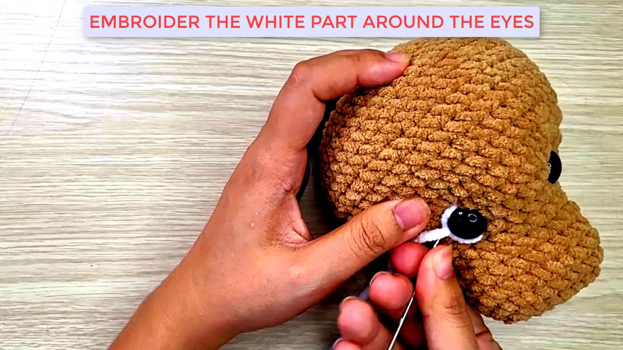 Mastering Amigurumi: A Step-by-Step Guide to Shaping and Embroidering a Dog's Face 8 A final look at the dog head, showing both eyes with their new white embroidered highlights, bringing the face to life.